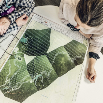 Two people looking at plans on a desk